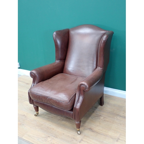 300 - A leather type upholstered Library Chair with turned front supports and casters