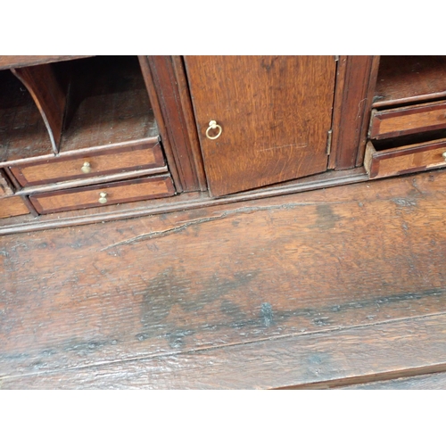 307 - An 18th Century oak Bureau with fitted interior above short and long drawers, 3ft 7in W A/F