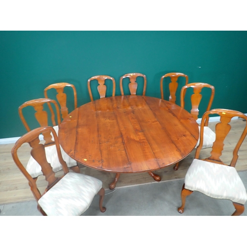 310 - A Bylaws cherrywood circular Dining Table and eight matching Chairs, the table with turned column an... 