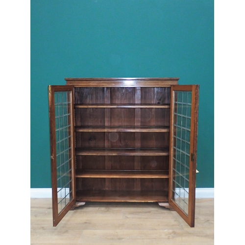 32 - An oak Bookcase fitted pair of lead glazed doors enclosing adjustable shelves 4ft 2in L x 3ft 5in W