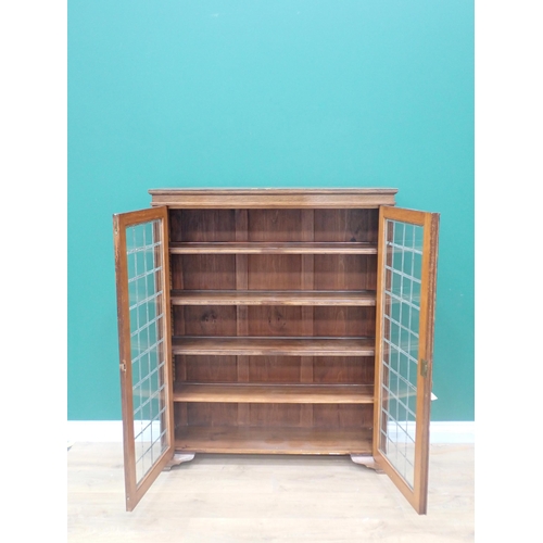 32 - An oak Bookcase fitted pair of lead glazed doors enclosing adjustable shelves 4ft 2in L x 3ft 5in W