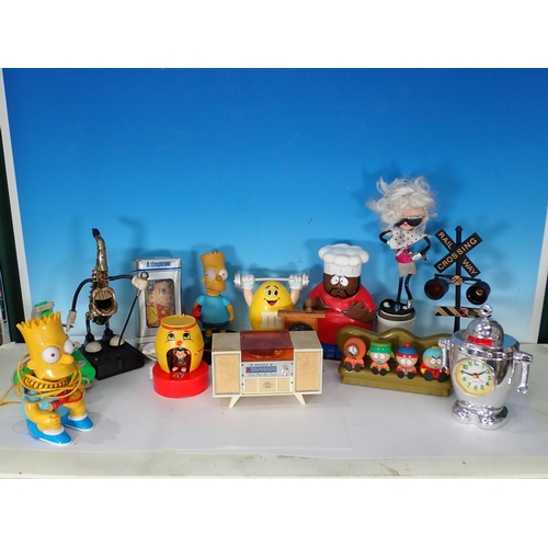 323 - A box containing novelty Figures including Simpsons, also a novelty clock etc