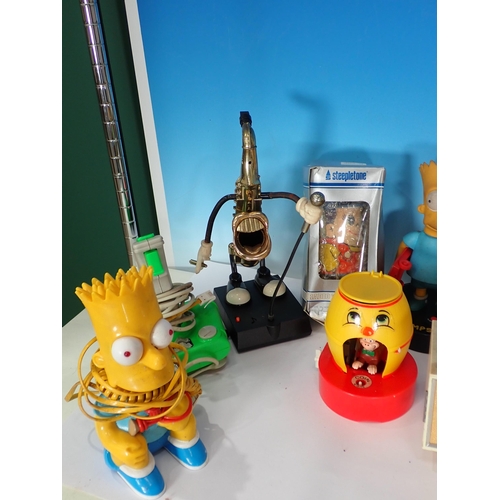 323 - A box containing novelty Figures including Simpsons, also a novelty clock etc