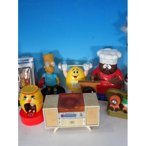 323 - A box containing novelty Figures including Simpsons, also a novelty clock etc