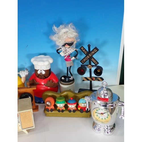 323 - A box containing novelty Figures including Simpsons, also a novelty clock etc