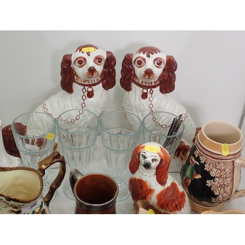 388 - A pair of hand painted Staffordshire seated Spaniels, another seated Spaniel figure, a ceramic Pengu... 