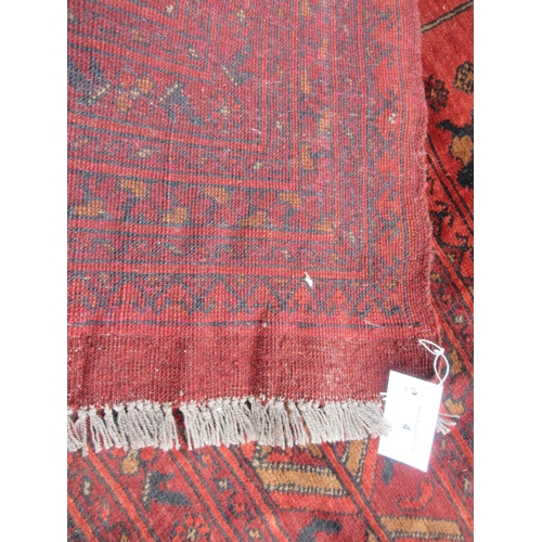 4 - A multi-bordered Afghan Carpet with geometric design on a red ground, 11ft 4in x 7ft 7in