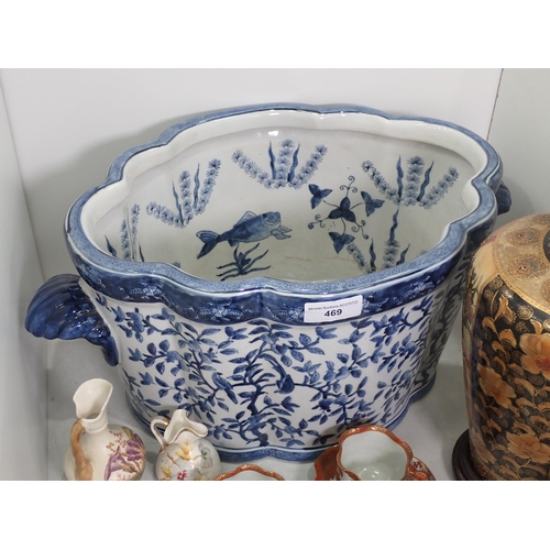 469 - A blue and white Jardinière decorated with trees and birds on the outside and fish to the interior s... 