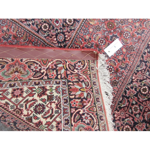 5 - A bordered Persian Rug with floral design in diamond field, 6ft x 3ft 7in