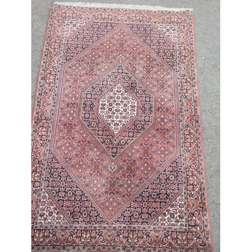 5 - A bordered Persian Rug with floral design in diamond field, 6ft x 3ft 7in