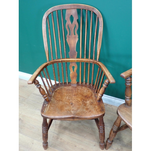 537 - A near pair of Windsor ash back Elbow Chairs with pierced splat backs on turned supports and stretch... 