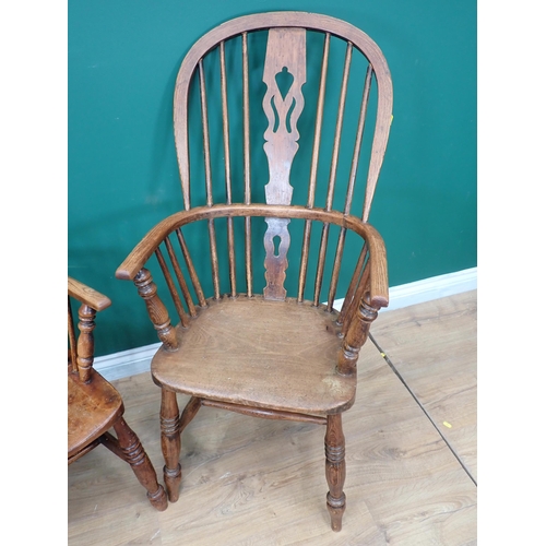 537 - A near pair of Windsor ash back Elbow Chairs with pierced splat backs on turned supports and stretch... 