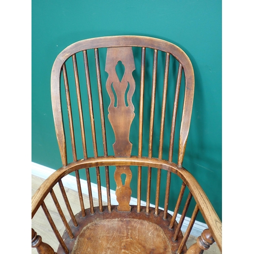 537 - A near pair of Windsor ash back Elbow Chairs with pierced splat backs on turned supports and stretch... 