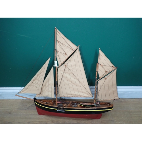 539 - A brass mounted piece of saddlery, a leather ammunition Pouch and a model of Sailing Boat