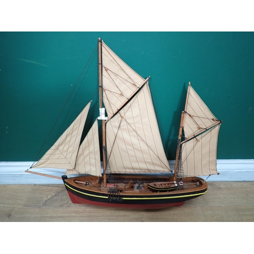 539 - A brass mounted piece of saddlery, a leather ammunition Pouch and a model of Sailing Boat