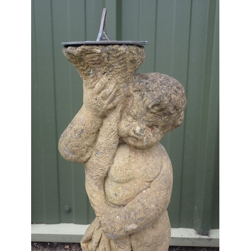 544 - A composite stone Sun Dial in the form of a figure, 2ft 5in H