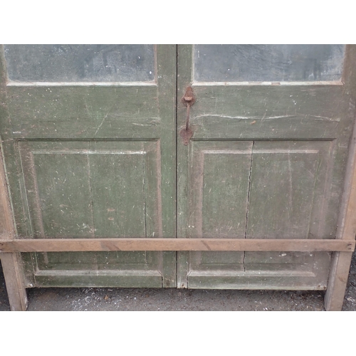 551 - A large pair of green painted glazed Doors, A/F, 7ft 5in H x 3ft 12in W (excluding frame)