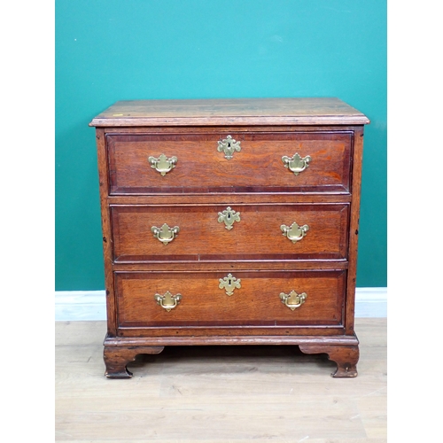 592 - A Georgian oak and mahogany crossbanded small Chest of three long drawers mounted on shaped bracket ... 