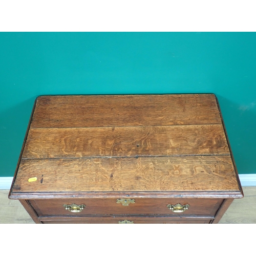 592 - A Georgian oak and mahogany crossbanded small Chest of three long drawers mounted on shaped bracket ... 