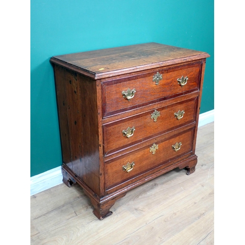 592 - A Georgian oak and mahogany crossbanded small Chest of three long drawers mounted on shaped bracket ... 