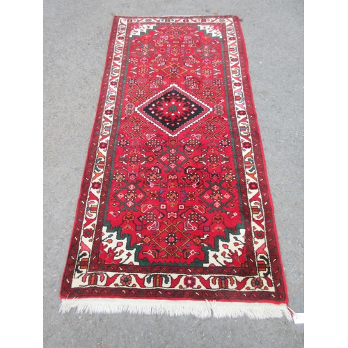 6 - A modern bordered Persian Rug with palmette design on a red ground, green stepped corners, 6ft 6in x... 