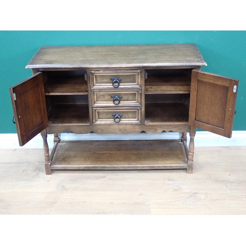 633 - A modern oak linenfold Sideboard fitted two cupboard doors flanking three drawers