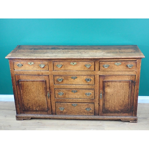 643 - An 18th Century oak and mahogany crossbanded enclosed Dresser Base fitted three frieze drawers above... 