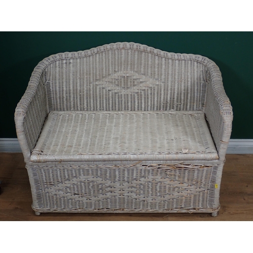 693 - A white cane two seater Settee