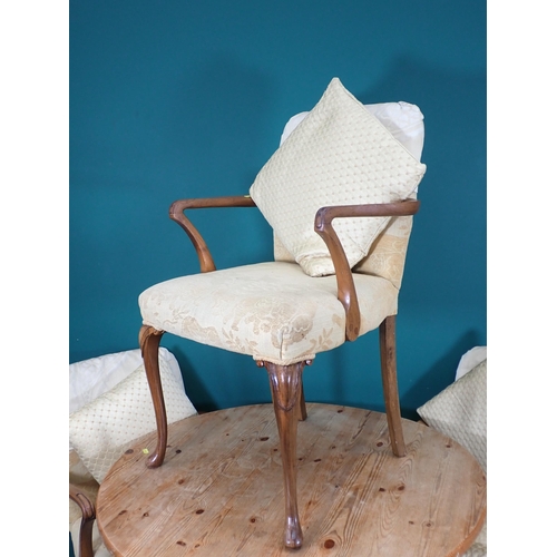 698 - A pine circular Breakfast Table and three Elbow Chairs on cabriole supports with yellow upholstery