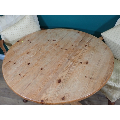 698 - A pine circular Breakfast Table and three Elbow Chairs on cabriole supports with yellow upholstery