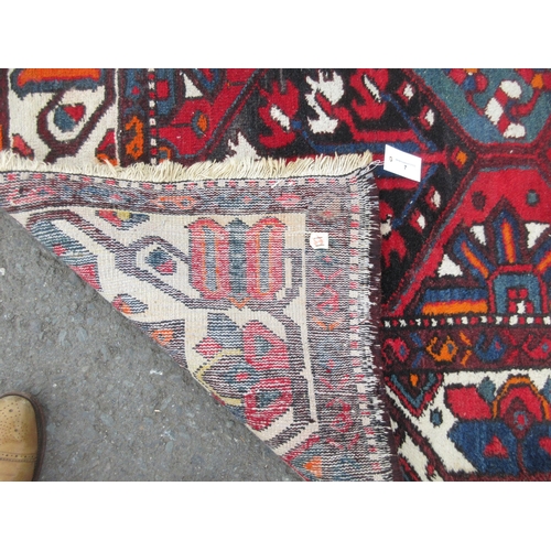 7 - A bordered Ferahagn type Carpet with stylised leafage, palmette and arrowhead lozenges in red, blue,... 