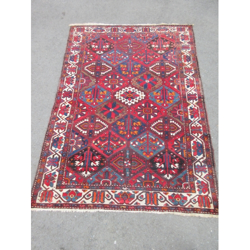 7 - A bordered Ferahagn type Carpet with stylised leafage, palmette and arrowhead lozenges in red, blue,... 