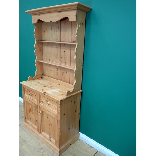 705A - A small pine Dresser and Rack, the base fitted two drawers and two cupboards, 6ft 2in H x 3ft W