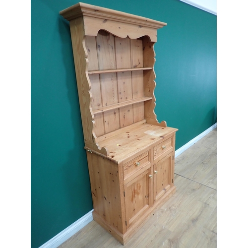 705A - A small pine Dresser and Rack, the base fitted two drawers and two cupboards, 6ft 2in H x 3ft W