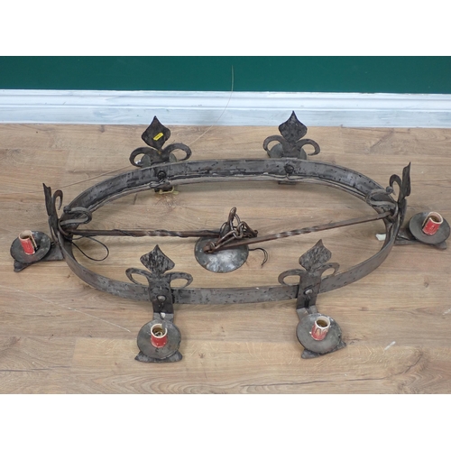 715 - An oval arts and crafts steel Light Fitting with Prince of Wales motifs and candle sconces, 3ft W ap... 