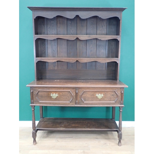 718 - A dark oak Dresser with open shelves above two moulded drawers on turned supports and potboard base,... 