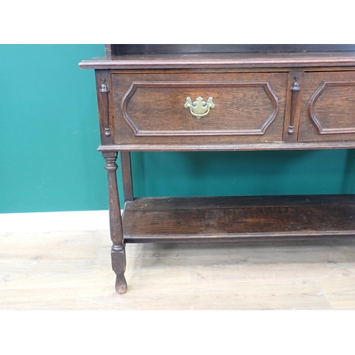 718 - A dark oak Dresser with open shelves above two moulded drawers on turned supports and potboard base,... 