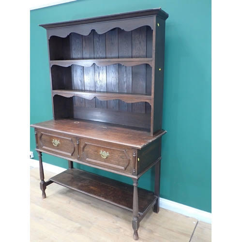 718 - A dark oak Dresser with open shelves above two moulded drawers on turned supports and potboard base,... 