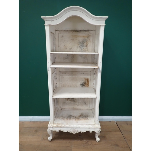 720 - A white painted open Bookcase with arched top on cabriole supports, 6ft 5in H