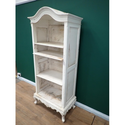 720 - A white painted open Bookcase with arched top on cabriole supports, 6ft 5in H