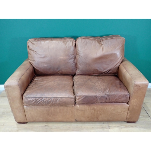 72A - A tan leather two seat Settee 5ft 5in w