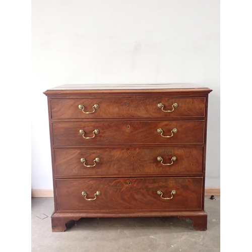 732 - A Georgian mahogany Chest with moulded top above four graduated drawers mounted on ogee bracket feet... 