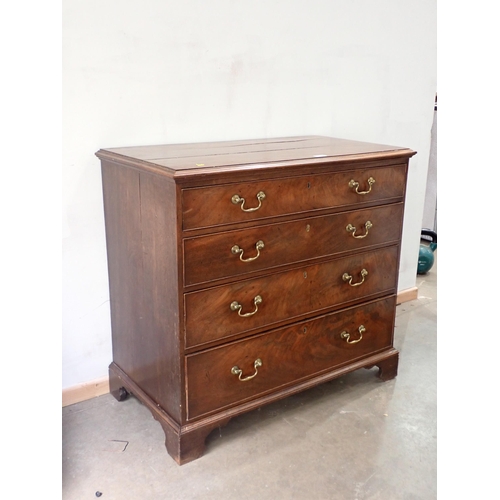 732 - A Georgian mahogany Chest with moulded top above four graduated drawers mounted on ogee bracket feet... 