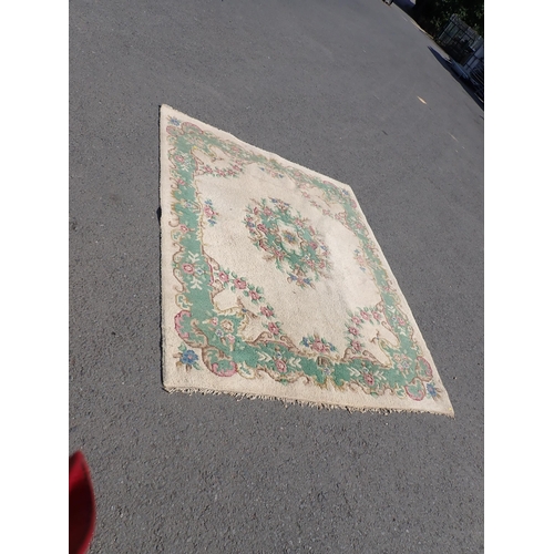 733 - A cream ground Carpet with green border and rose design 106in x 90in