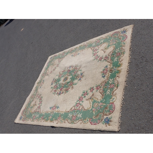 733 - A cream ground Carpet with green border and rose design 106in x 90in