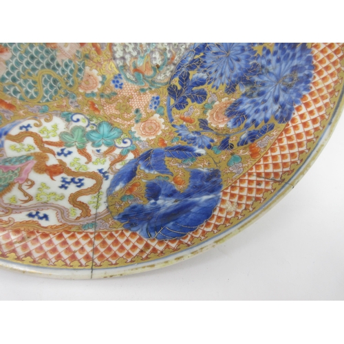 88 - An Imari Bowl finely painted dragons amongst clouds and flowering shrubs in iron red, blue, green an... 