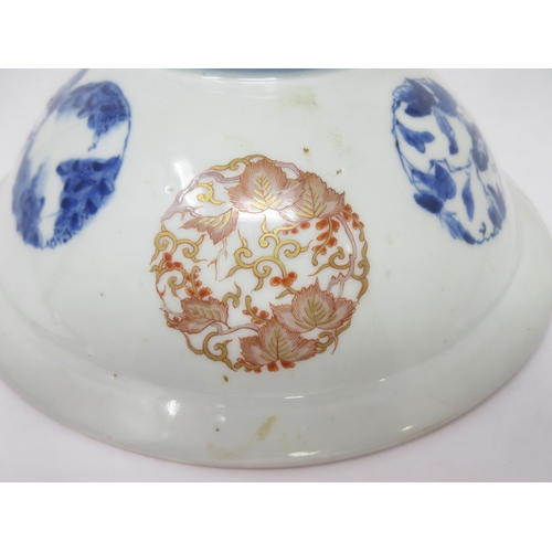 88 - An Imari Bowl finely painted dragons amongst clouds and flowering shrubs in iron red, blue, green an... 