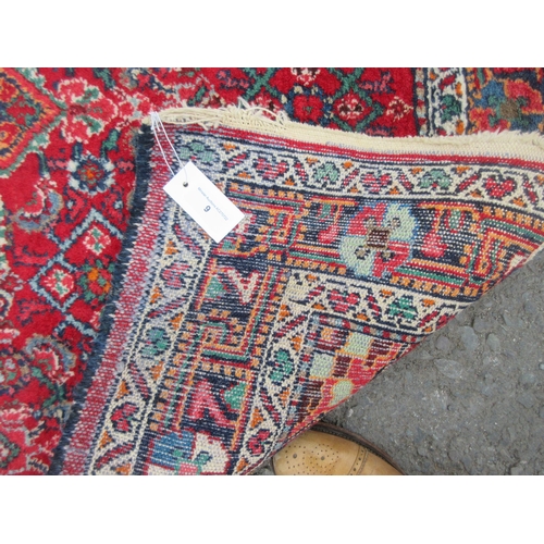 9 - A bordered Persian Rug with herati pattern on a red ground