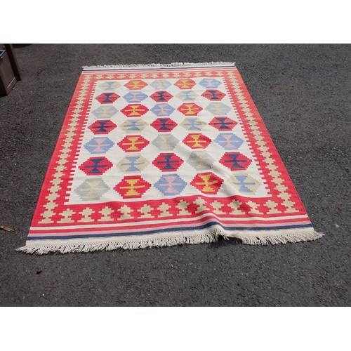 523 - An Ikea Rug decorated multi-coloured medallions on a cream ground, 8ft x 5ft 8In