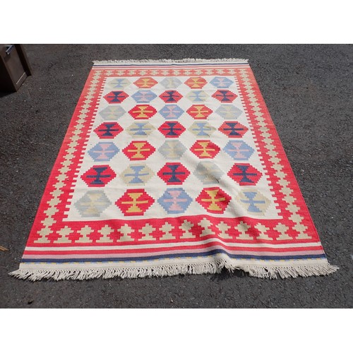 523 - An Ikea Rug decorated multi-coloured medallions on a cream ground, 8ft x 5ft 8In